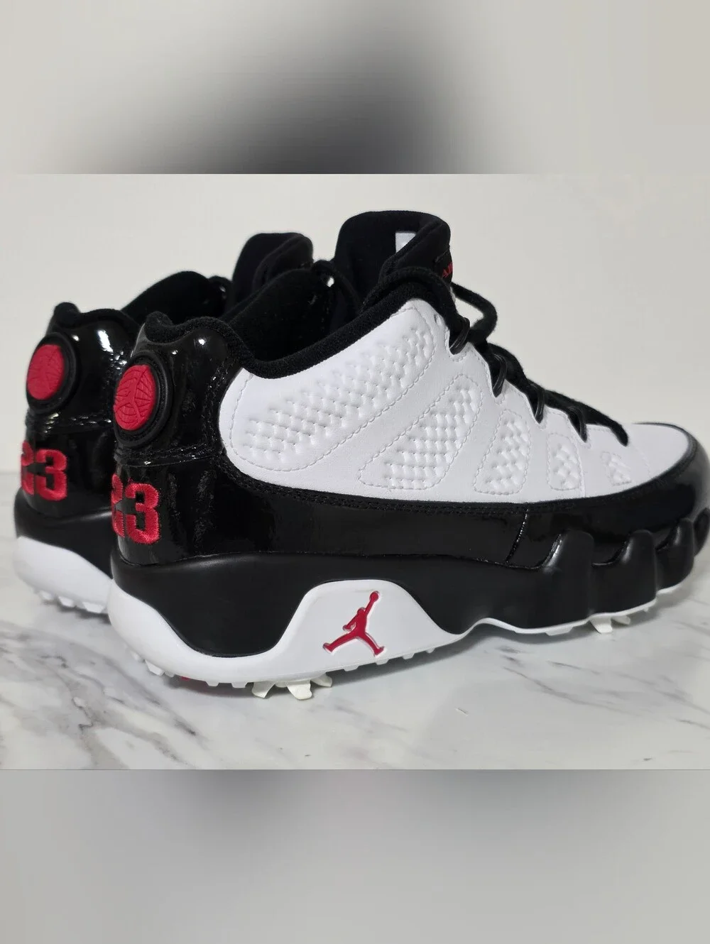 Jordan White and Black Golf Cleats with Red Logo